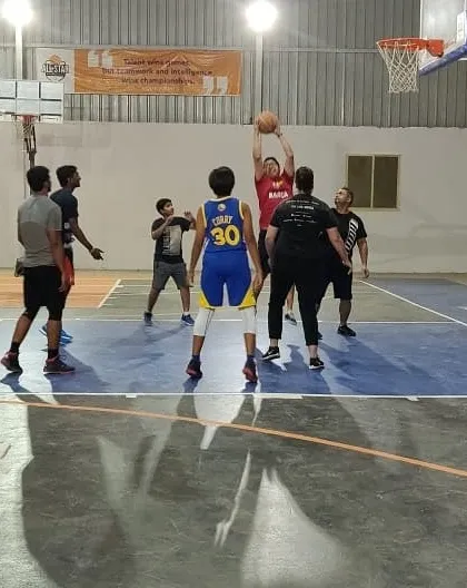 Friends enjoying a half-court game. You can book the court for smaller groups to work on skills or play 3-on-3.