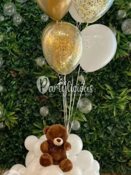 Creating moments that are nothing short of bear-y beautiful. A sweet teddy bear sits amongst a cloud of white and gold confetti balloons.