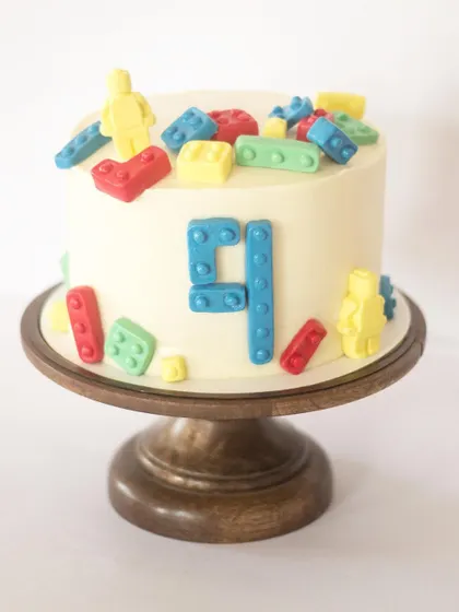 Lego theme cakes are always a hit with kids. This one features colorful fondant Lego bricks and minifigures. It's a simple, fun, and recognizable theme that all the kids at the party will love.