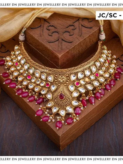 A heavy Kundan choker with ruby bead drops. This is a royal and opulent piece, perfect for a bride who wants to make a grand statement.
