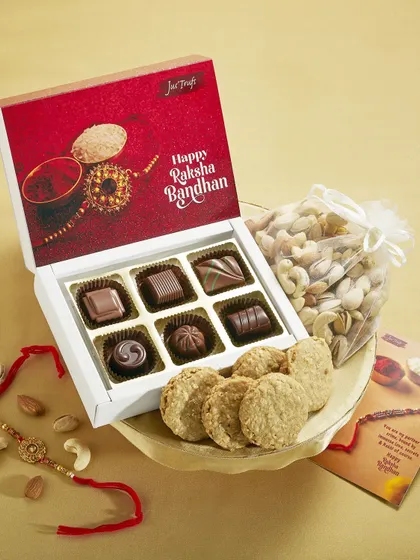 Our red Rakhi gift box pairs chocolates with a bag of nuts, cookies and an occasion card.