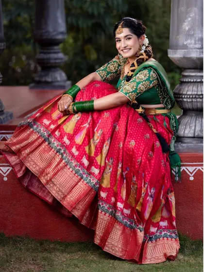 The client seated gracefully, showing the beautiful fall of the red printed skirt.