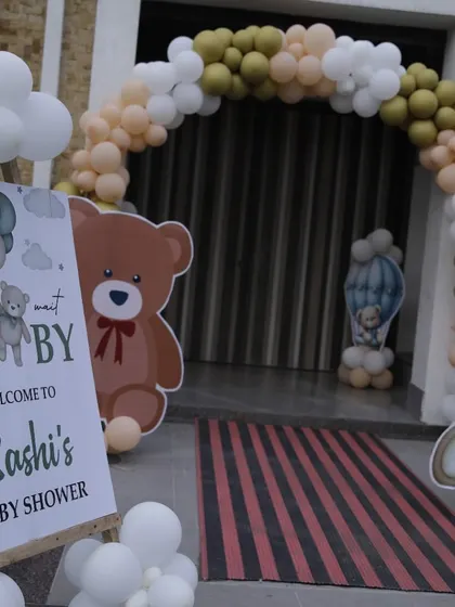 An inviting entrance to a teddy bear-themed baby shower, with a welcome easel and cute bear cutouts greeting the guests.