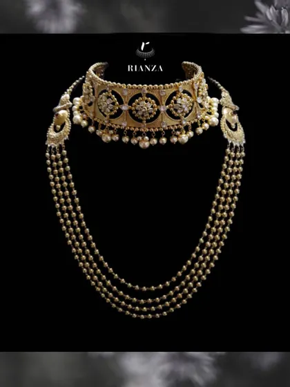 This is a perfect example of how we layer pieces for a complete bridal look. It features a traditional Rajwadi kundan choker paired with a multi-layered pearl and gold jaal necklace, creating a look of unmatched grace and heritage.