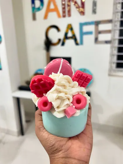 A similar cupcake candle design, this time in a lovely teal color with pink wax decorations.