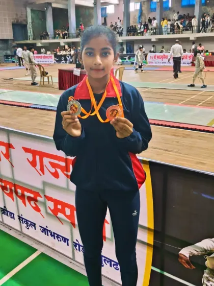 Soumya Sathe proudly displays her individual silver and team bronze medals from the Sub-junior State Fencing Championship. Her performance shows her versatility in both individual and team events.