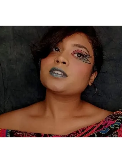 This pose captures the artistic and thoughtful mood of the butterfly-inspired makeup, showing how the look can be used for expressive photoshoots.