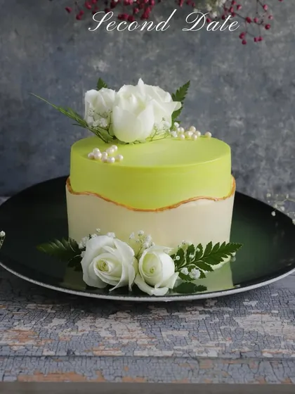 Perfect for a second date or a special anniversary. This stunning cake with a lime green glaze and fresh white roses is designed to make a memorable impression.