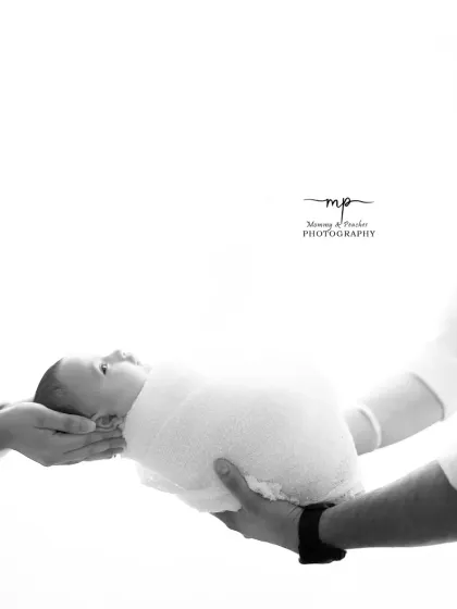 Held safely in loving hands. This symbolic black and white photo represents the promise and protection of family.