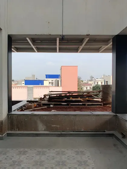 A view from a terrace under construction, looking out at the city.