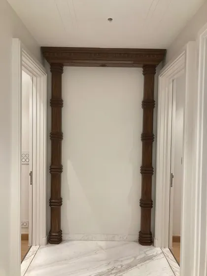 Not just a hallway, a statement of style, structure, and a little bit of old-world charm. These custom wooden columns transform a simple passage into a grand feature.