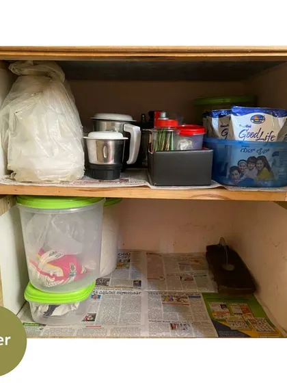 After clearing it out, the space is now neatly organized with a mixer and other appliances, making the cabinet much more functional.