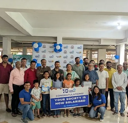 The entire community at Shivaprakruthi Society, including children, gathers for a group photo to celebrate their building going solar.