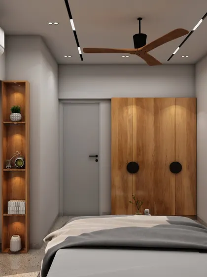 A minimalist bedroom with a unique wooden wardrobe featuring large circular handles, showcasing our love for simple yet impactful design details.
