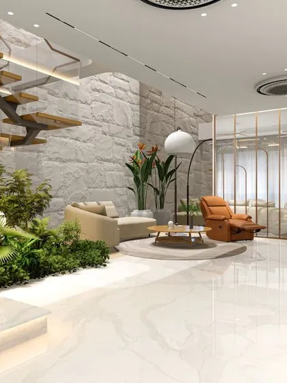 This bright, open-plan living area showcases our love for biophilic design, bringing nature indoors with a stunning green pocket under a custom floating staircase. The combination of natural stone flooring, warm wood steps, and abundant light creates a space that is both luxurious and deeply calming, embodying our approach to modern residential interiors.
