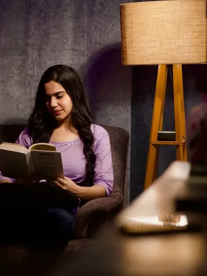 Lost in a good book. This shot is part of a series creating a cozy, peaceful atmosphere, showcasing my ability to portray different moods and characters for the camera.