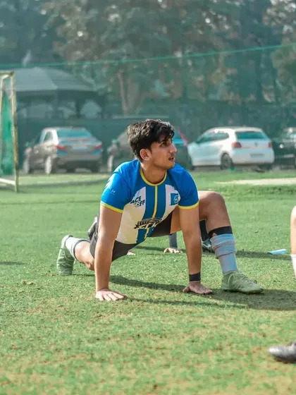 Players warming up and stretching before a big corporate match. Preparation is key.
