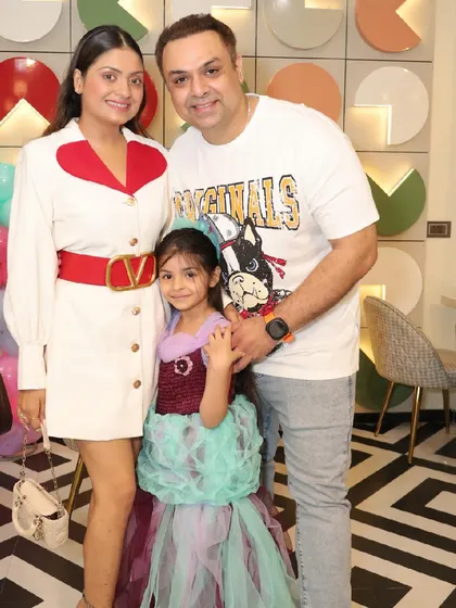 A happy family photo at a mermaid-themed celebration.