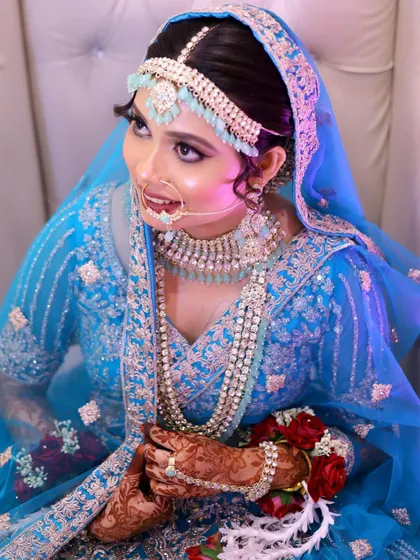 A happy and radiant Nikkah bride, her smile lighting up the frame. The makeup is glamorous yet feels light and ethereal.