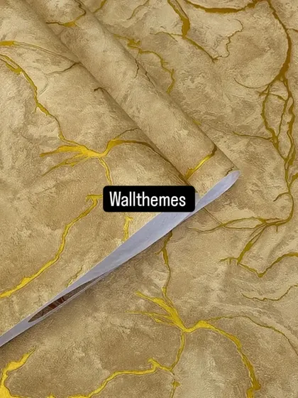 A warm, sand-colored wallpaper with a gold marble vein pattern.