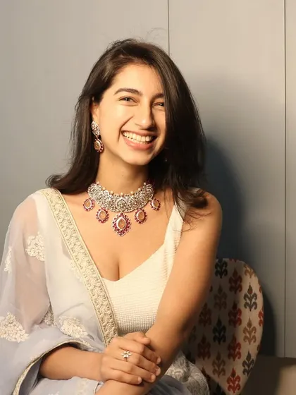 A smile that lights up the room. This client is wearing a custom-made pink stone and Polki diamond necklace set, and she looks absolutely radiant.