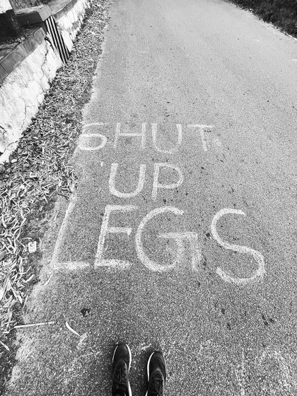 "Shut up legs." The mantra of every endurance runner, written on the road at Nandi Hills.