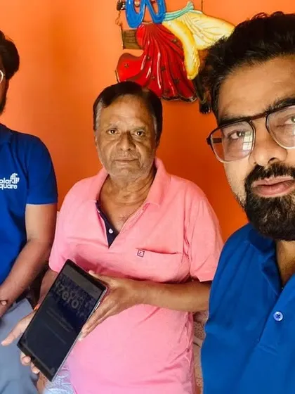Our team takes a selfie with a customer holding our solar guide.