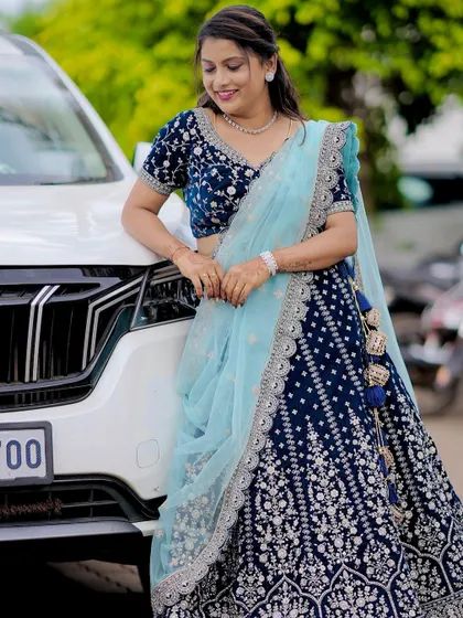 She looks absolutely radiant. The combination of the deep blue velvet and the light blue dupatta is a winner.