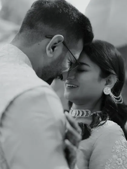 A close-up black and white shot of the couple, their faces close together, sharing a quiet, happy moment. This image is incredibly intimate and full of emotion.