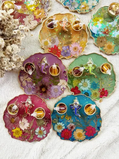 A colorful array of my handcrafted puja thalis, each one unique and filled with preserved flowers.