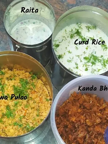 A simple, wholesome meal packed for delivery. This order included Tawa Pulao, Raita, Curd Rice, and crispy Kanda Bhaji (onion fritters).