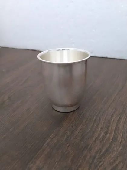 A simple, elegant German silver glass, a basic necessity for any pooja.