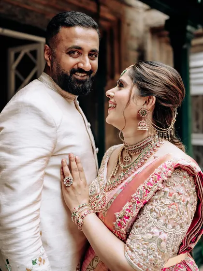 A playful moment between my husband and me. Our coordinated outfits reflect our personal style while staying true to traditional aesthetics.