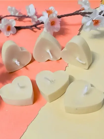 Simple and pure, these cream-colored heart-shaped candles are a versatile choice for any decor style or event theme.