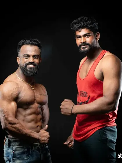 Standing with a client at Xtreme Fitness. My goal as a coach is to help you build a physique that you can be proud of.