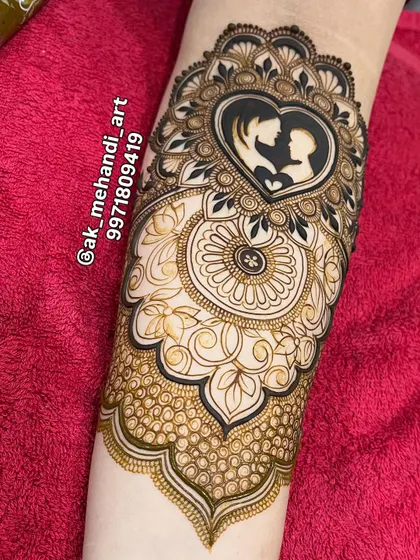 The design after the henna paste has been applied, showing the clean lines and intricate details of the mother and child silhouette.