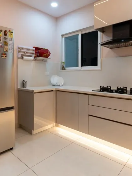 This view shows the kitchen's appliance corner, with the refrigerator and dedicated space for other small appliances, keeping the main counters free.