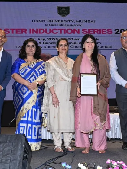 A group photograph on stage at the HSNC University after being honored as a 'Distinguished Professor of Practice'. It is a privilege to contribute to the education of the next generation.