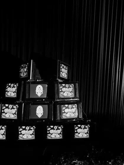 An installation of stacked vintage television sets displaying psychedelic, custom-made visuals. This retro-tech art piece was a major focal point and conversation starter.
