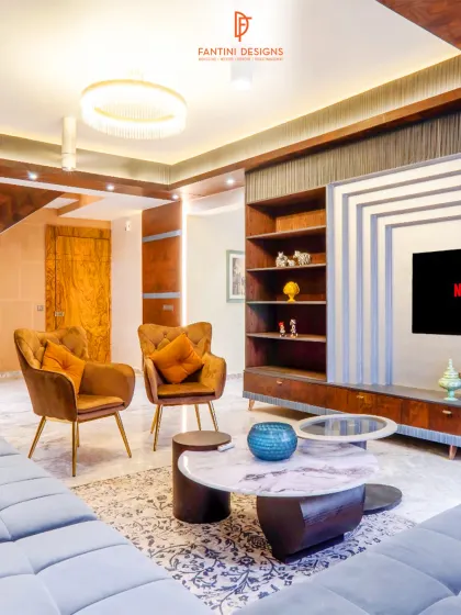 A full view of the living area, showing how the different elements come together. From the modern chandelier to the custom coffee table and plush seating, every piece is chosen to create a cohesive and luxurious feel.