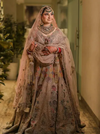 A wide shot of the bride in a hallway, her long veil creating a beautiful silhouette.