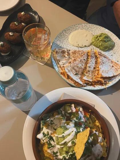 A delicious spread of Mexican food, including loaded nachos and cheesy quesadillas. This is from a local bar in Barcelona that inspired me with its relaxed vibe and flavourful food.
