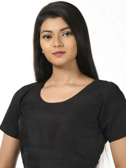 A simple black cotton blouse with short sleeves, a versatile staple for any wardrobe.