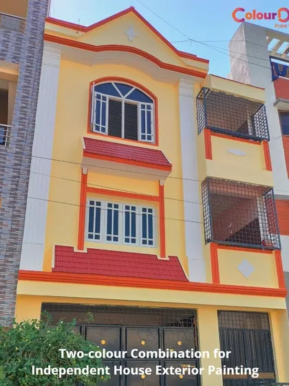 A classic two-color combination of yellow and orange with white trim for an independent house. This vibrant palette gives the building a warm and welcoming appearance, highlighting its traditional architectural details.