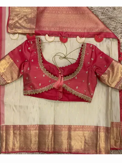 The back of the red blouse laid over the saree, showing the contrast and the custom tassels.