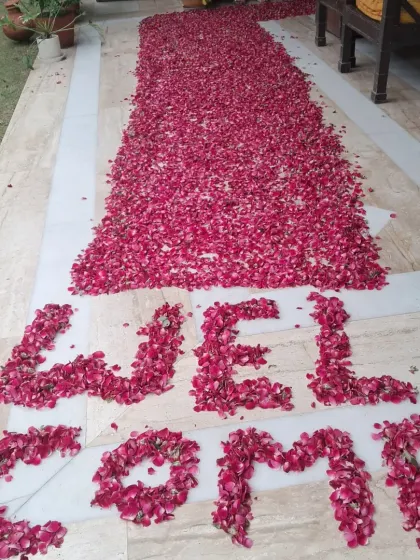 This is a welcome pathway I created using a thick arrangement of fresh red rose petals. The word 'WELCOME' is clearly spelled out at the entrance to greet the person arriving home.