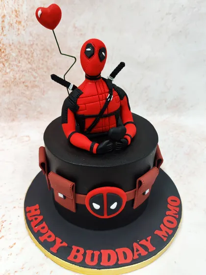 We bring the "Merc with a Mouth" to the party with this striking Deadpool cake. A detailed figure of the anti-hero sits atop a sleek black cake, complete with his utility belt and a heart-shaped balloon for a touch of his signature humor.