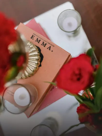 A thoughtful detail from an engagement party decor, where a copy of the classic novel "Emma" is used as a decorative element. This personal touch adds a layer of storytelling to the event.