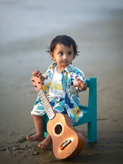 A thoughtful moment for our little beach bard. The soft evening light and the sound of the waves create a peaceful setting for a child's portrait.