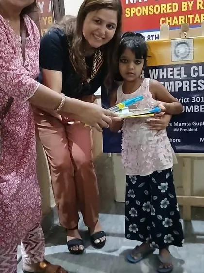 Handing out new pencils and notebooks to a young student. I believe that supporting a child's education is just as important as teaching them about nutrition.